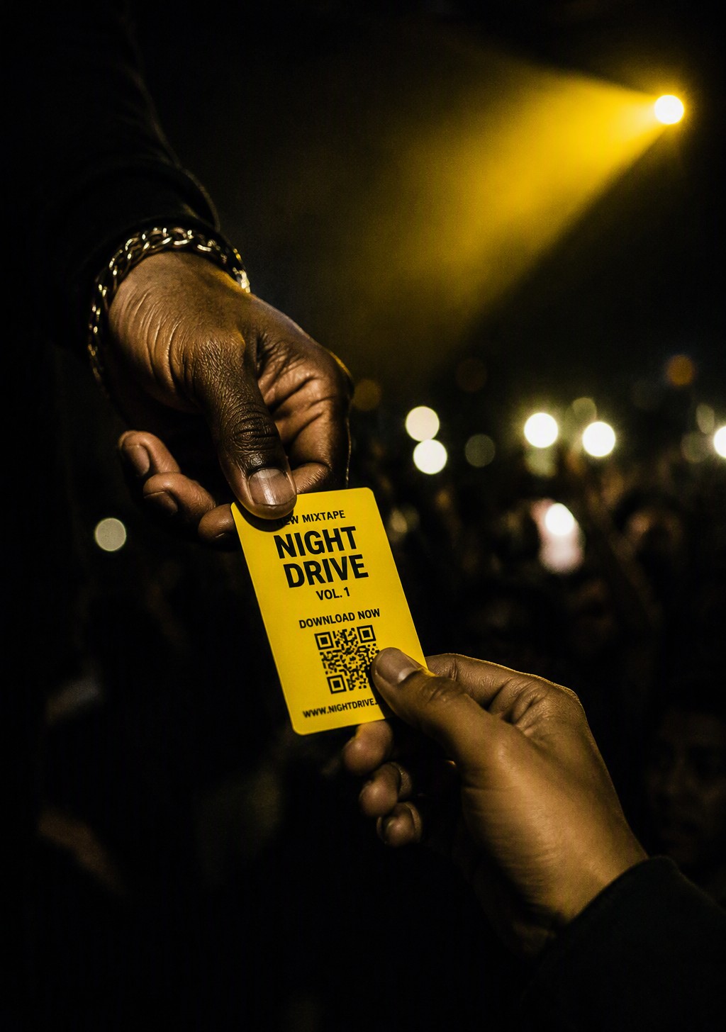 An artist handing a yellow Slappcard music download card to a fan at a night show